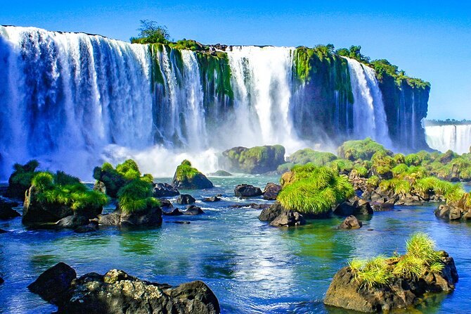 Green islands splitting the water above the drop