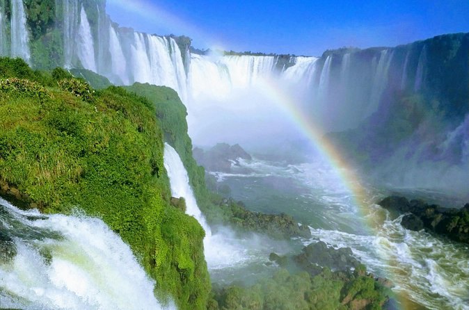 A rainbow standing in the spray below the falls