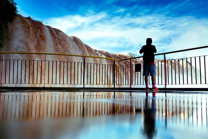 A walkway out over the river, the falls beyond